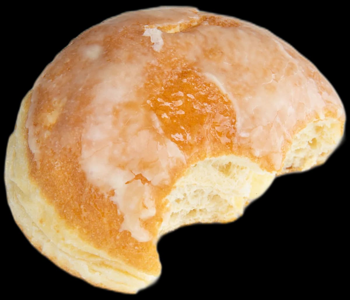 A raised glazed donut with a bite taken out