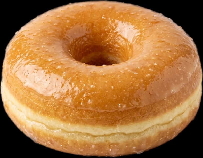 A raised glazed donut, honey glaze still glossy