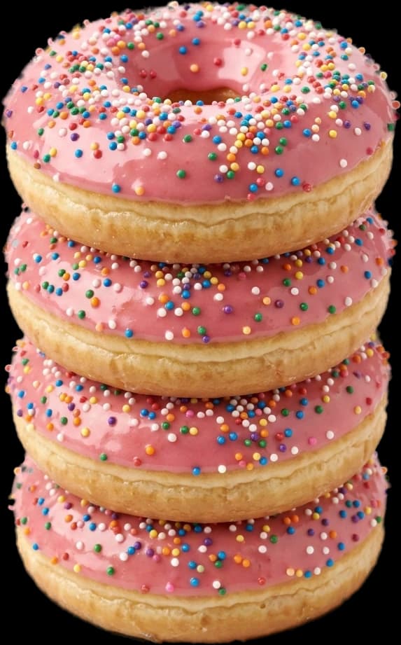 A stack of three sprinkle-glazed donuts