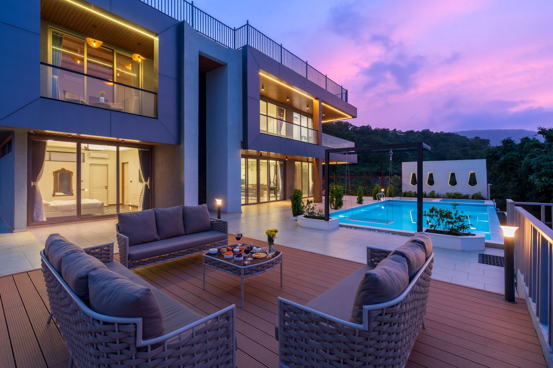 Cantilevered volumes and warm strip light under a violet dusk sky