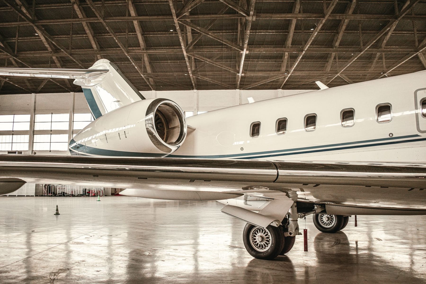 A super-midsize jet under hangar lights