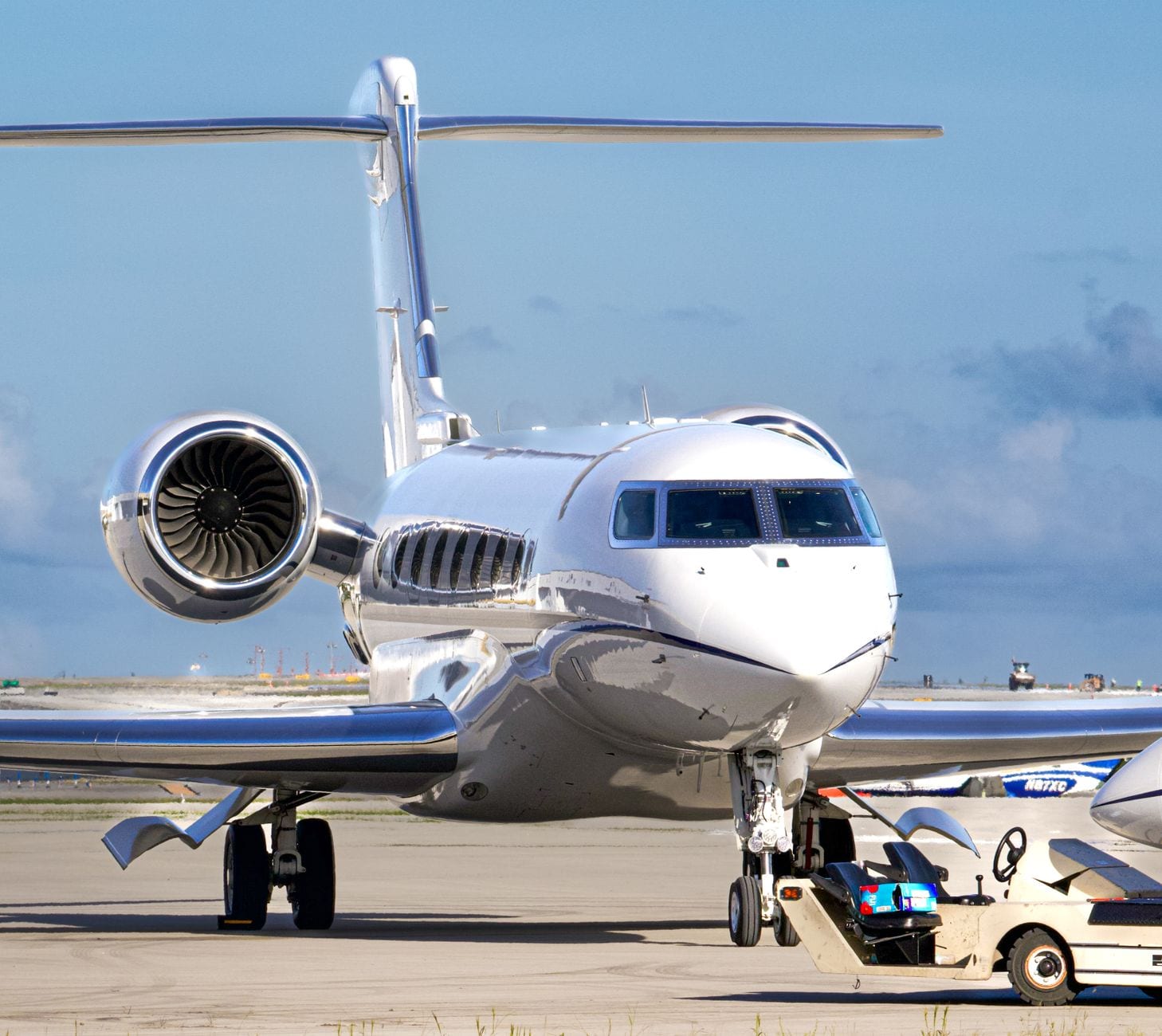 The nose and engine of a business jet on the ramp